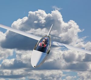 A young woman is learing how to fly a glider.